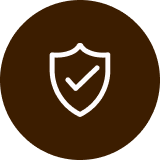 A white line icon of a shield with a checkmark inside, set against a brown circle.