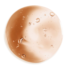 A circular smear of amber-colored transparent gel with bubbles on a white background.