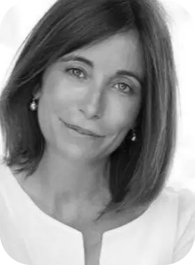 Black and white portrait of a woman with shoulder-length hair, wearing earrings and a white top.
