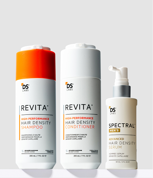 Three DS Labs hair products: Revita shampoo and conditioner, and Spectral Men's hair density serum, against a light background.