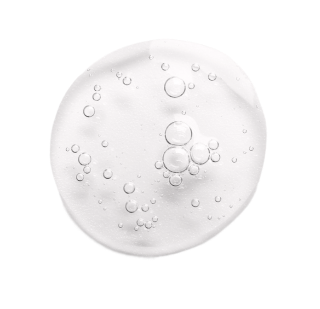 A clear, circular drop of liquid with bubbles inside, isolated on a white background.
