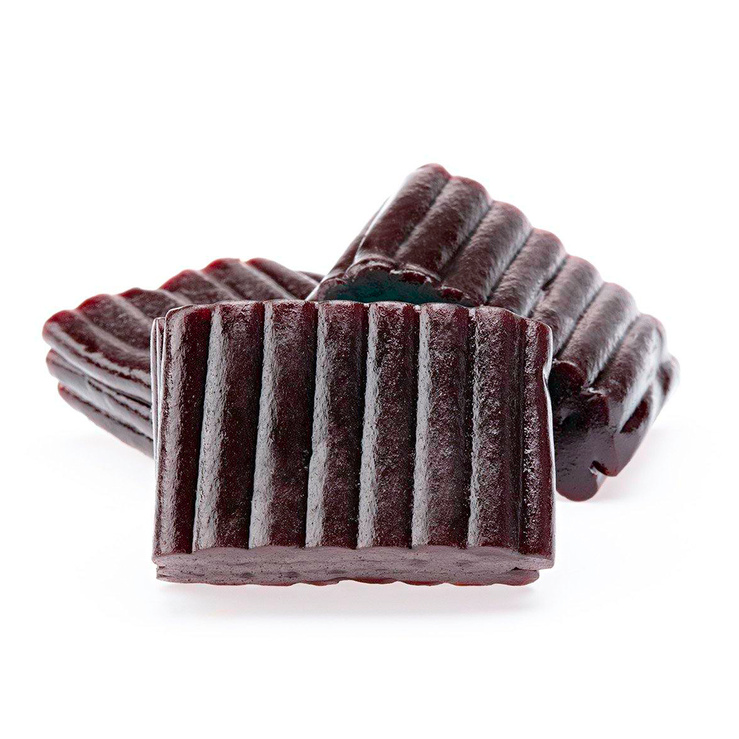 Three pieces of dark, ridged candy on a white background.
