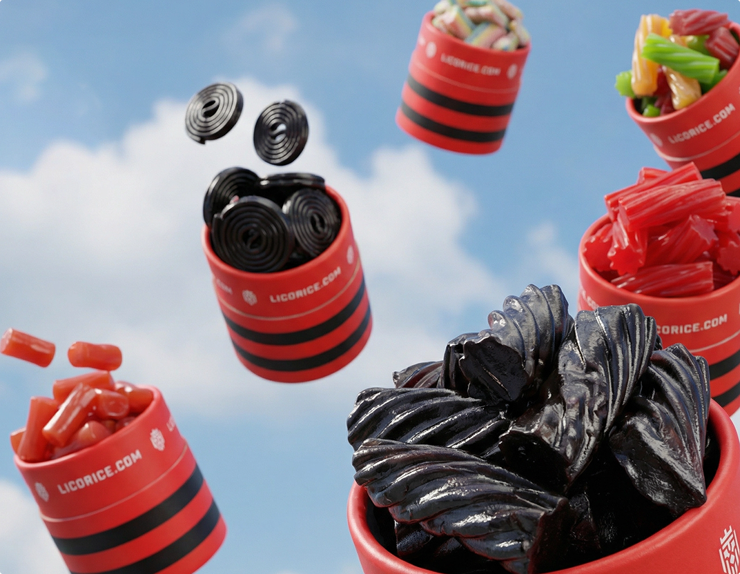 Red and black striped cups of assorted licorice candy floating against a blue sky.