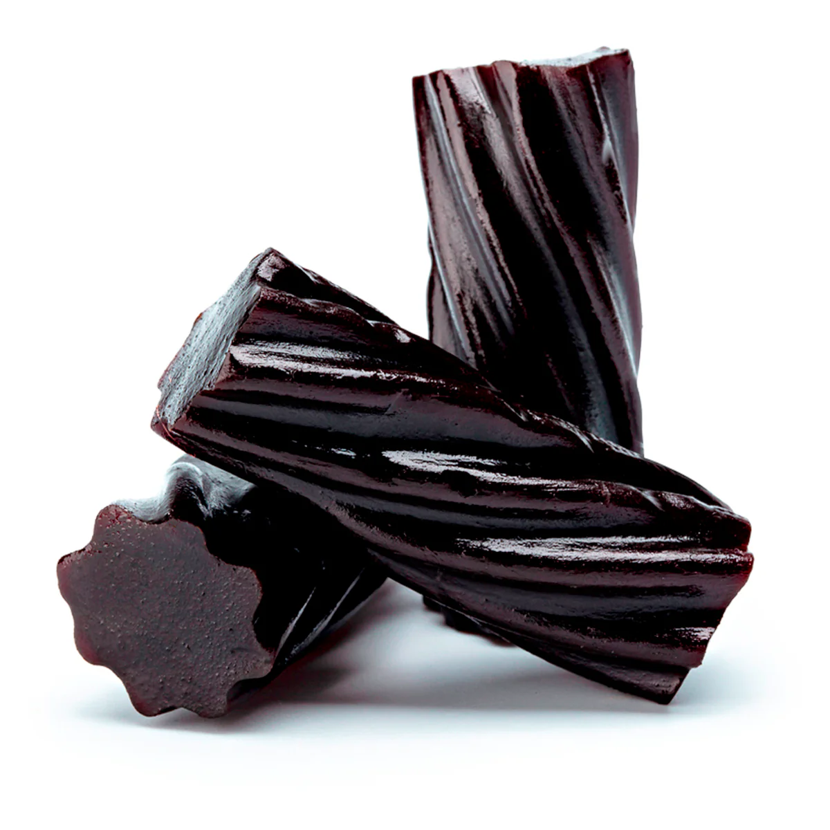 Three pieces of black licorice with a twisted texture.