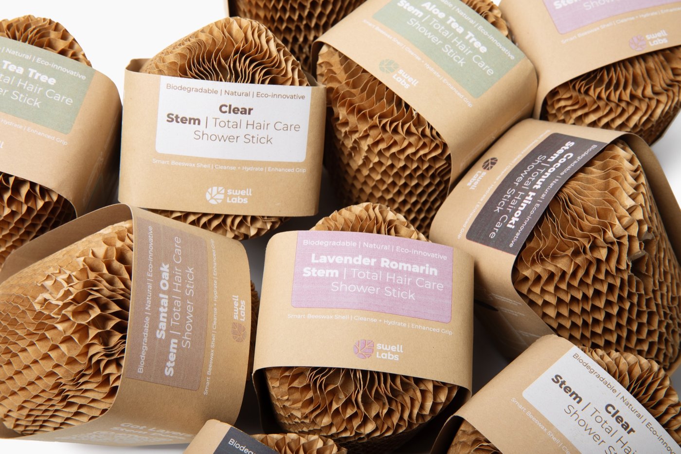 A close-up assortment of Stem Hair and Body bars in their honeycomb protective packaging
