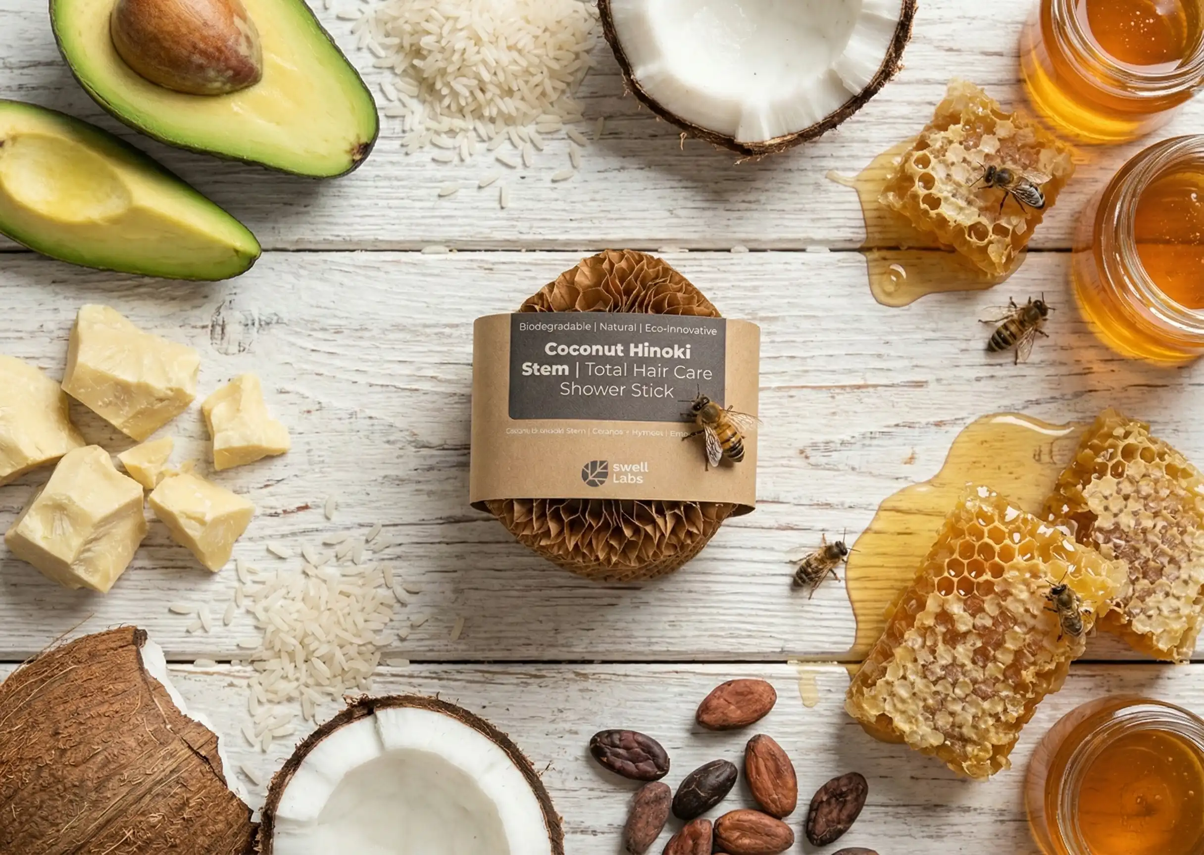 Various natural ingredients and a hair care product on white wood.