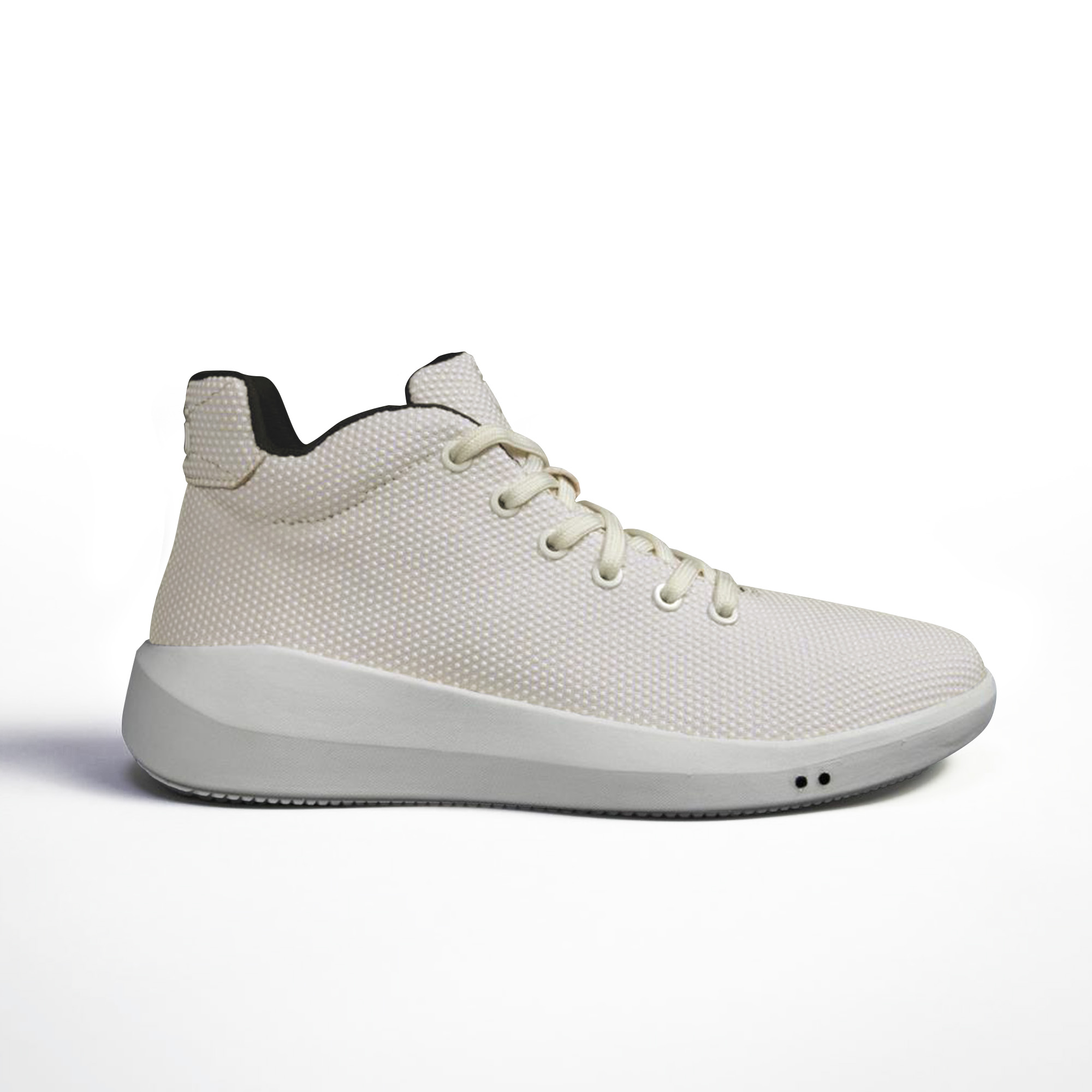 A sleek, light-colored sneaker with a textured surface and white sole.