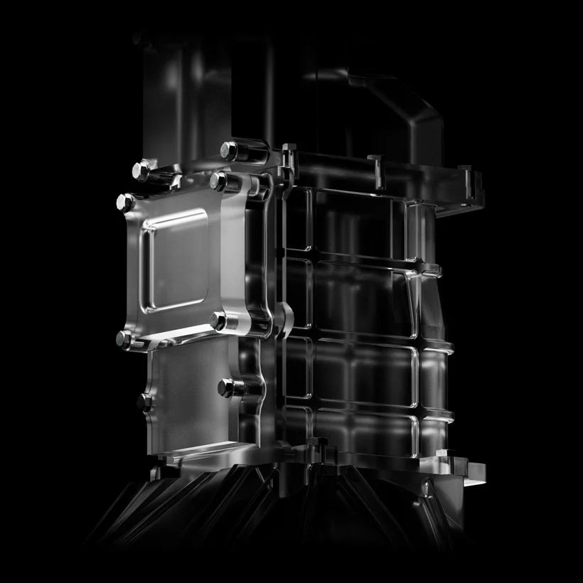 Close-up of a metallic, industrial component with bolts, against a black background.