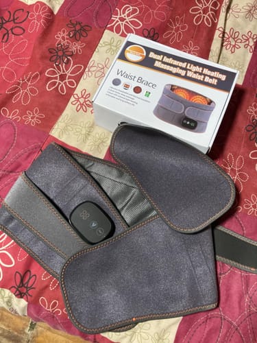Infrared heating waist belt and packaging on a floral-patterned fabric.