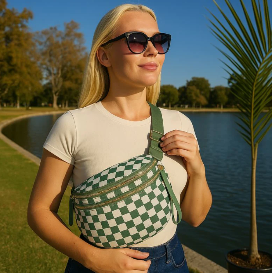 Woman with sunglasses and checkered bag by a lake.