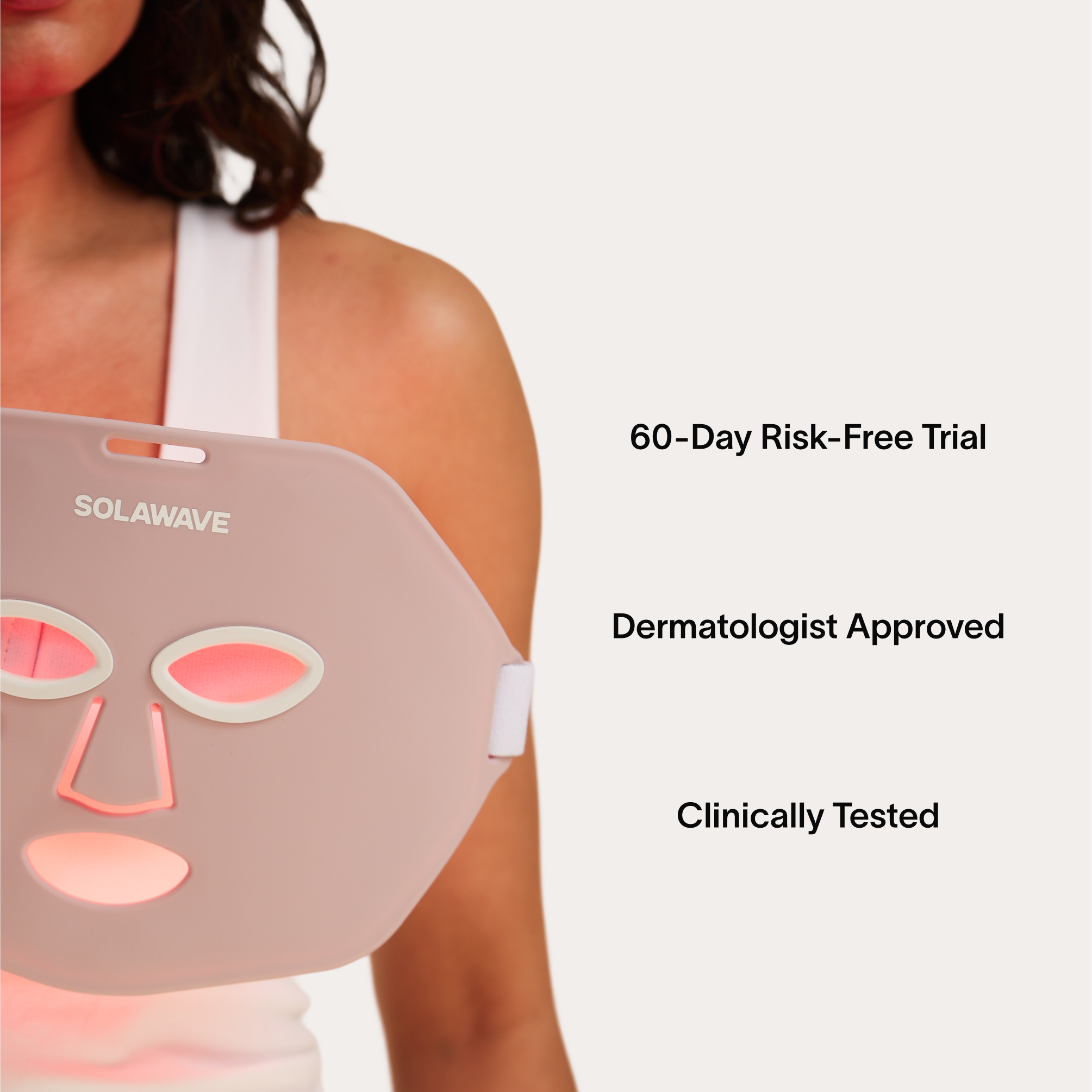 Person holding a pink LED face mask with text about a 60-day trial.