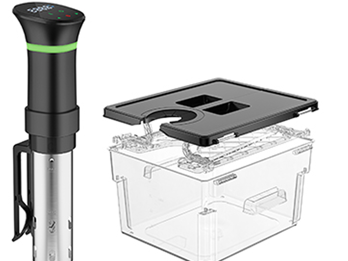 Sous vide immersion circulator next to a transparent container with a lid.