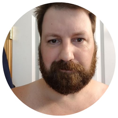 A bearded man with short hair, looking directly at the camera.