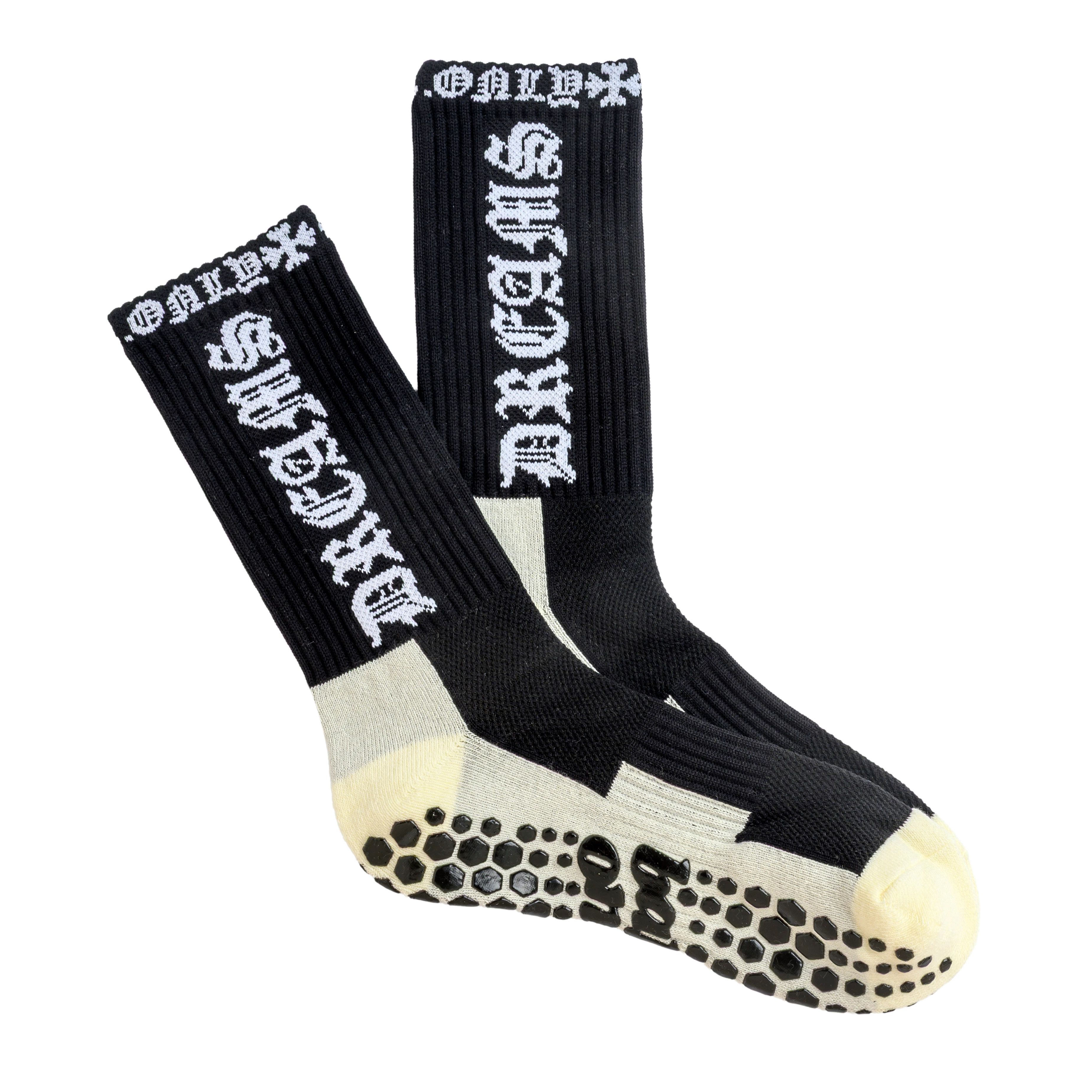 A pair of black crew socks with white gothic lettering and non-slip grips on the soles.