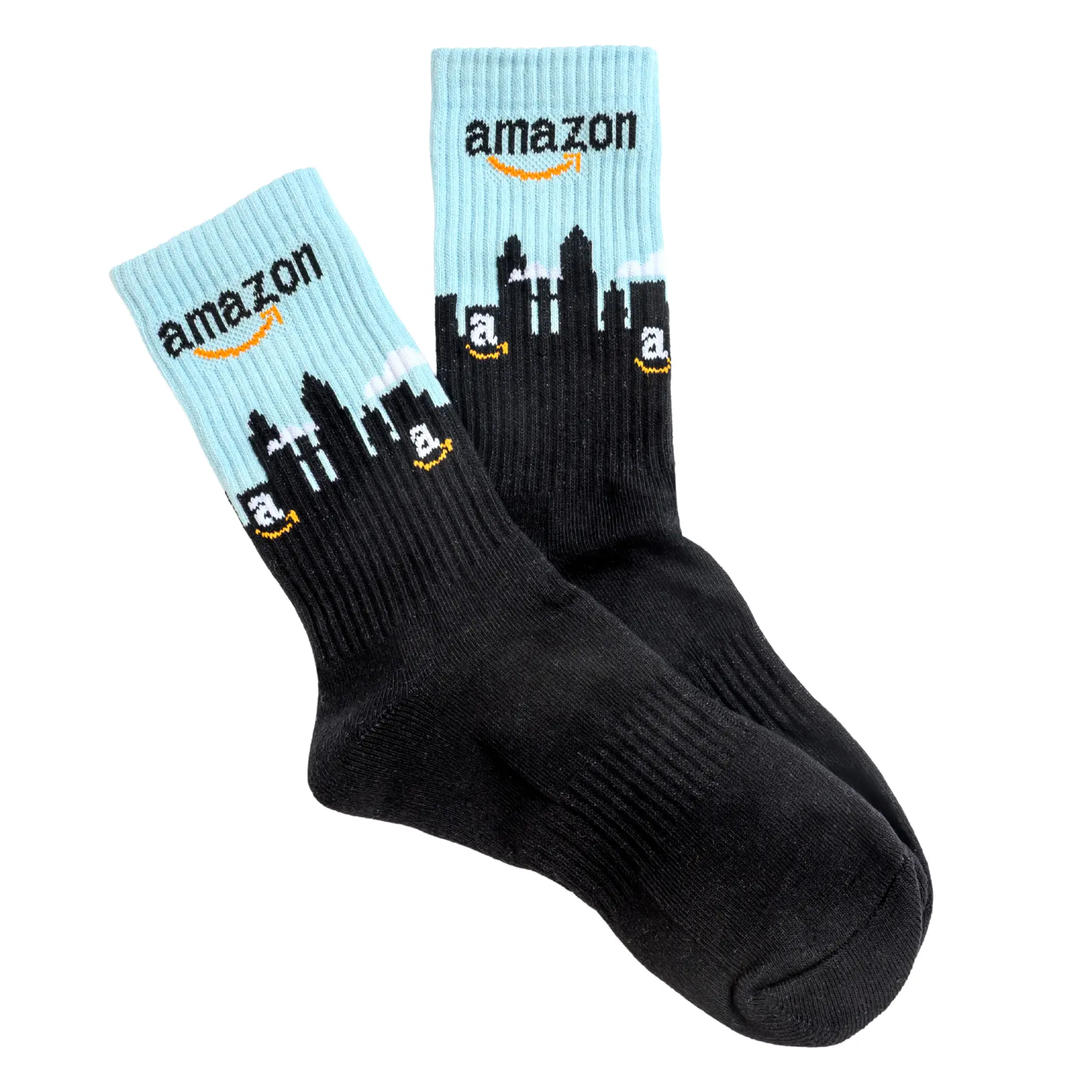 A pair of black and light blue socks featuring the Amazon logo and a city skyline.