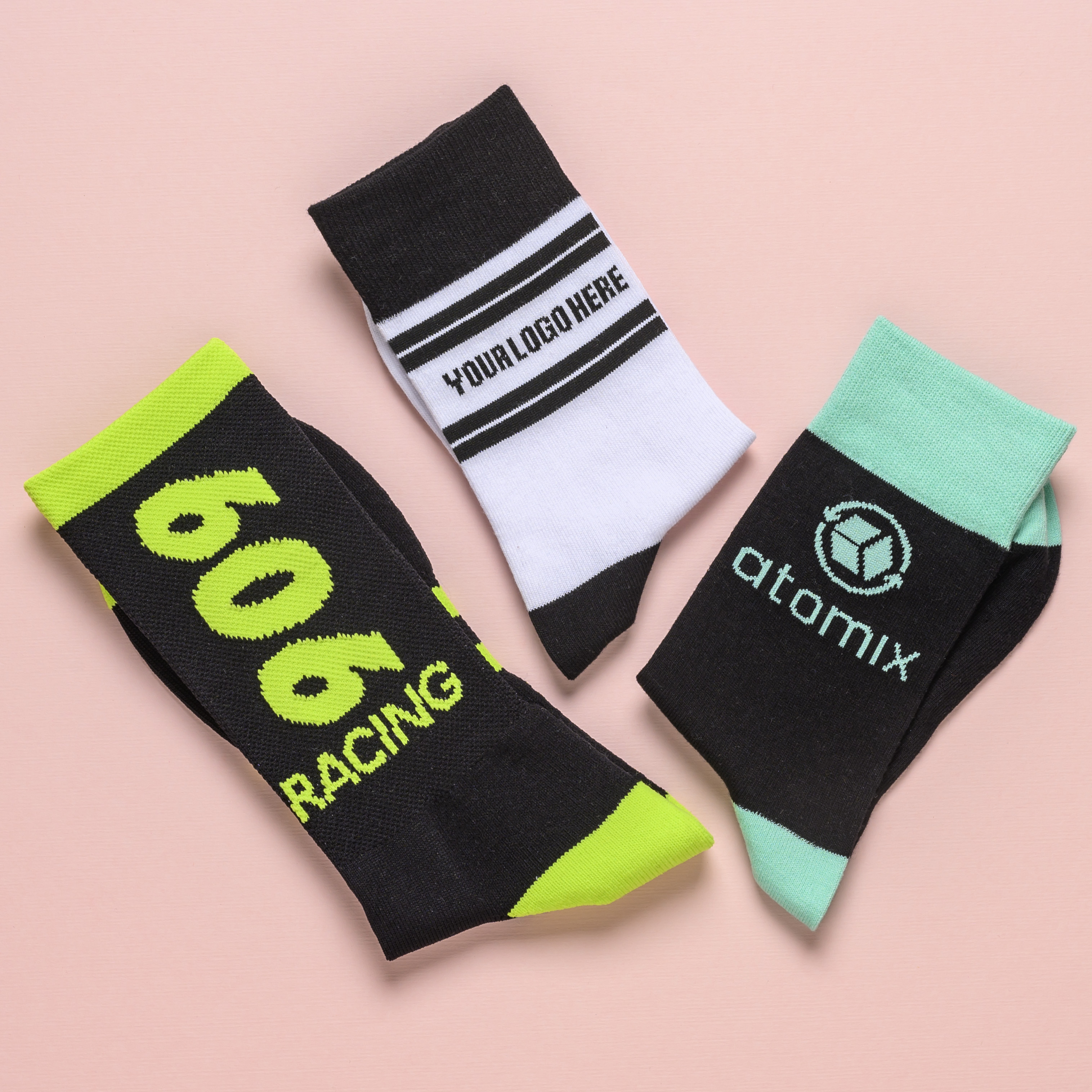 A set of custom athletic socks featuring bold logo designs and vibrant color combinations.