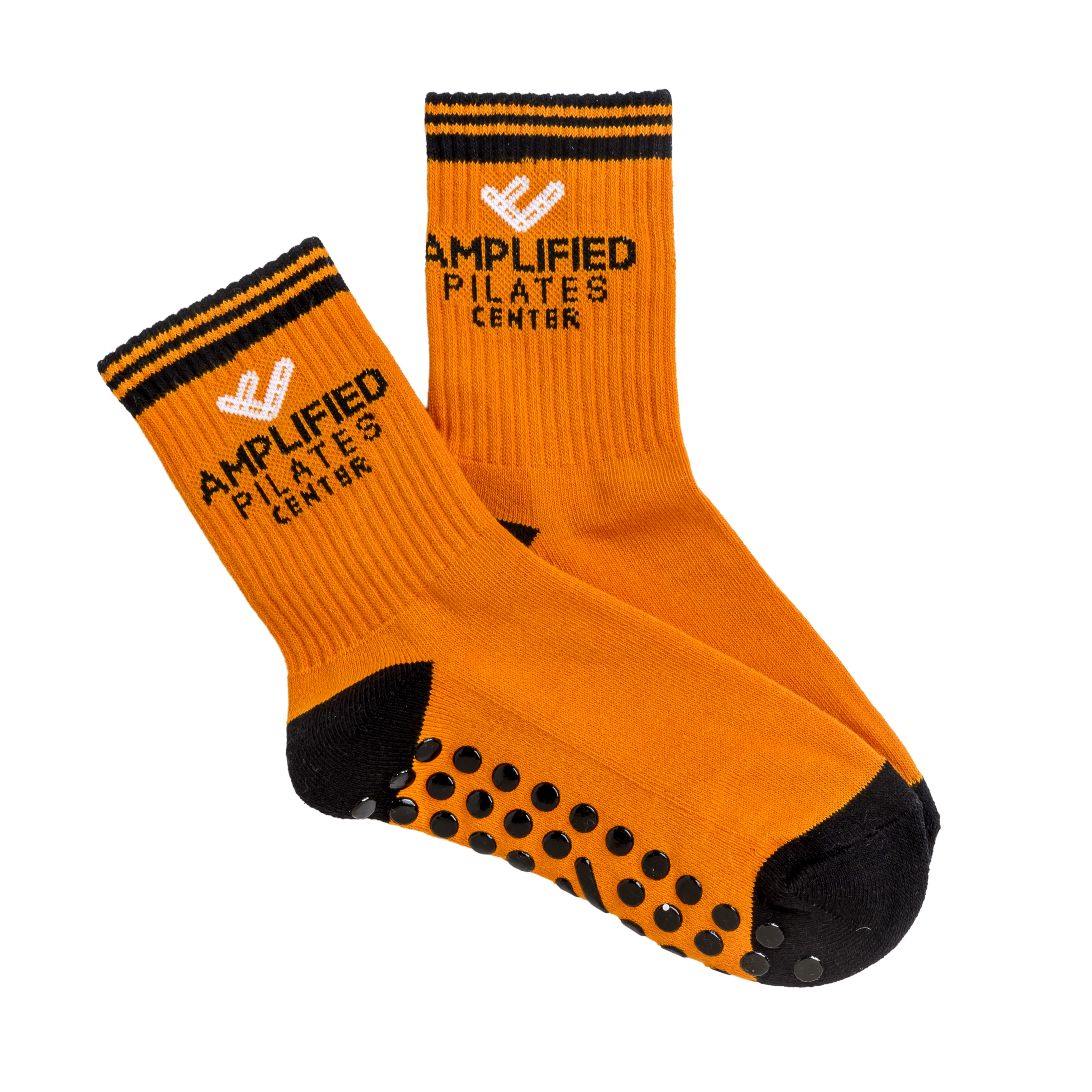 A pair of orange and black grip socks with the Amplified Pilates Center logo.