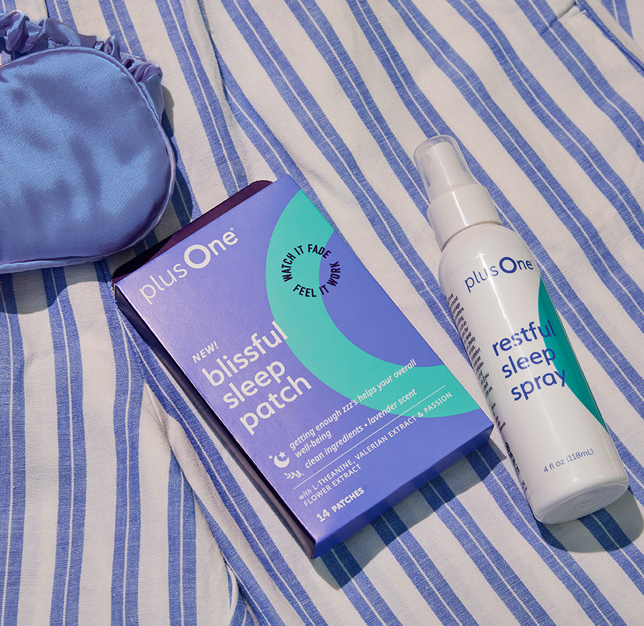 Sleep mask, Blissful Sleep Patch box, and Restful Sleep Spray bottle on striped fabric.