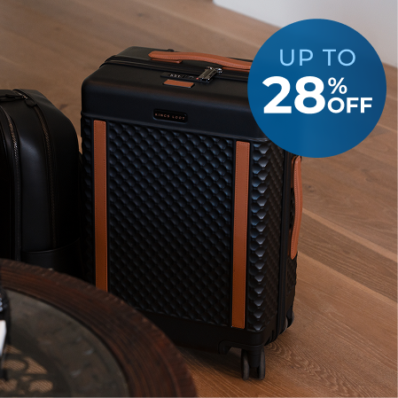 A black suitcase with a textured pattern and tan accents, overlaid with a 'Up to 28% Off' graphic.