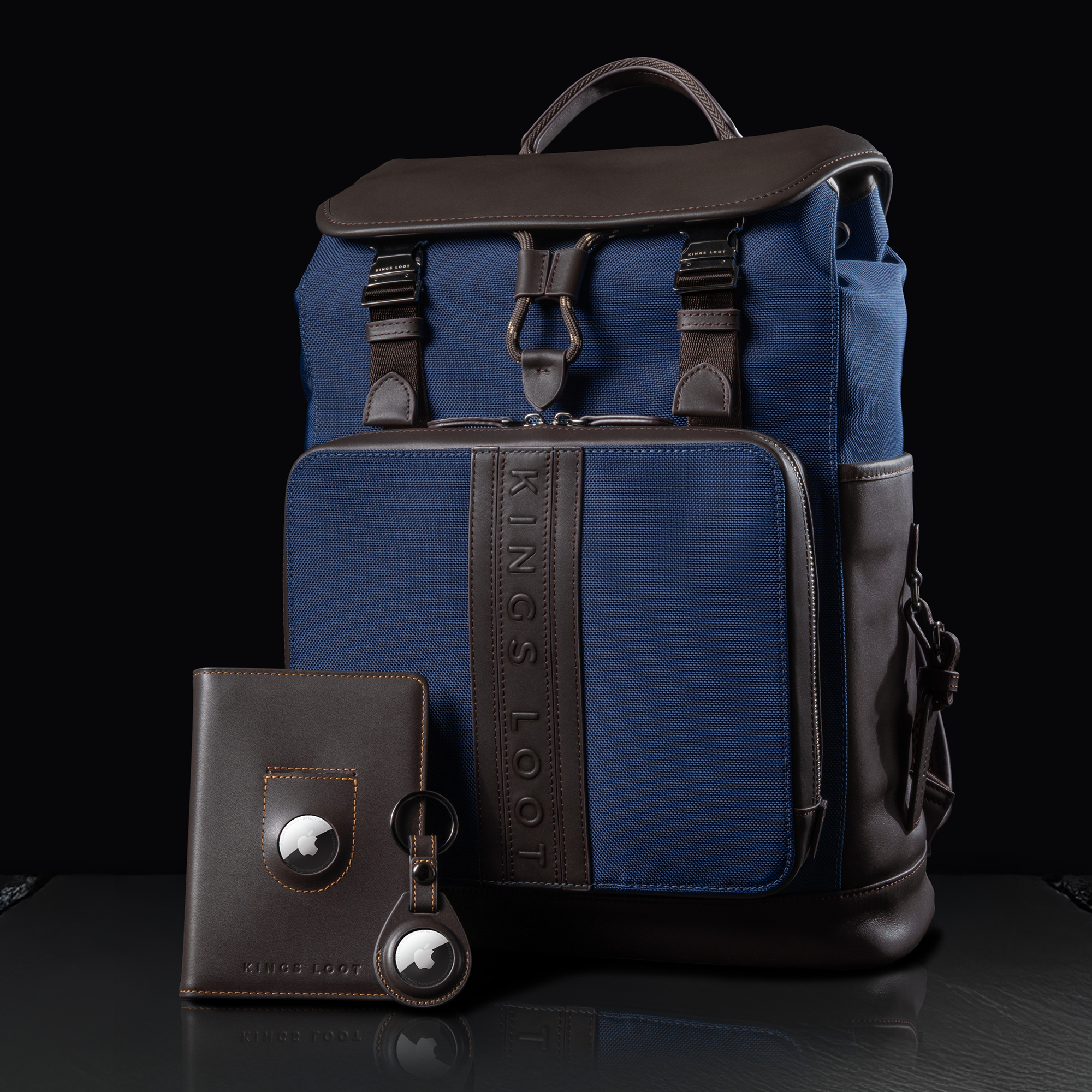 Blue and brown backpack with matching wallet and keychain on a dark background.