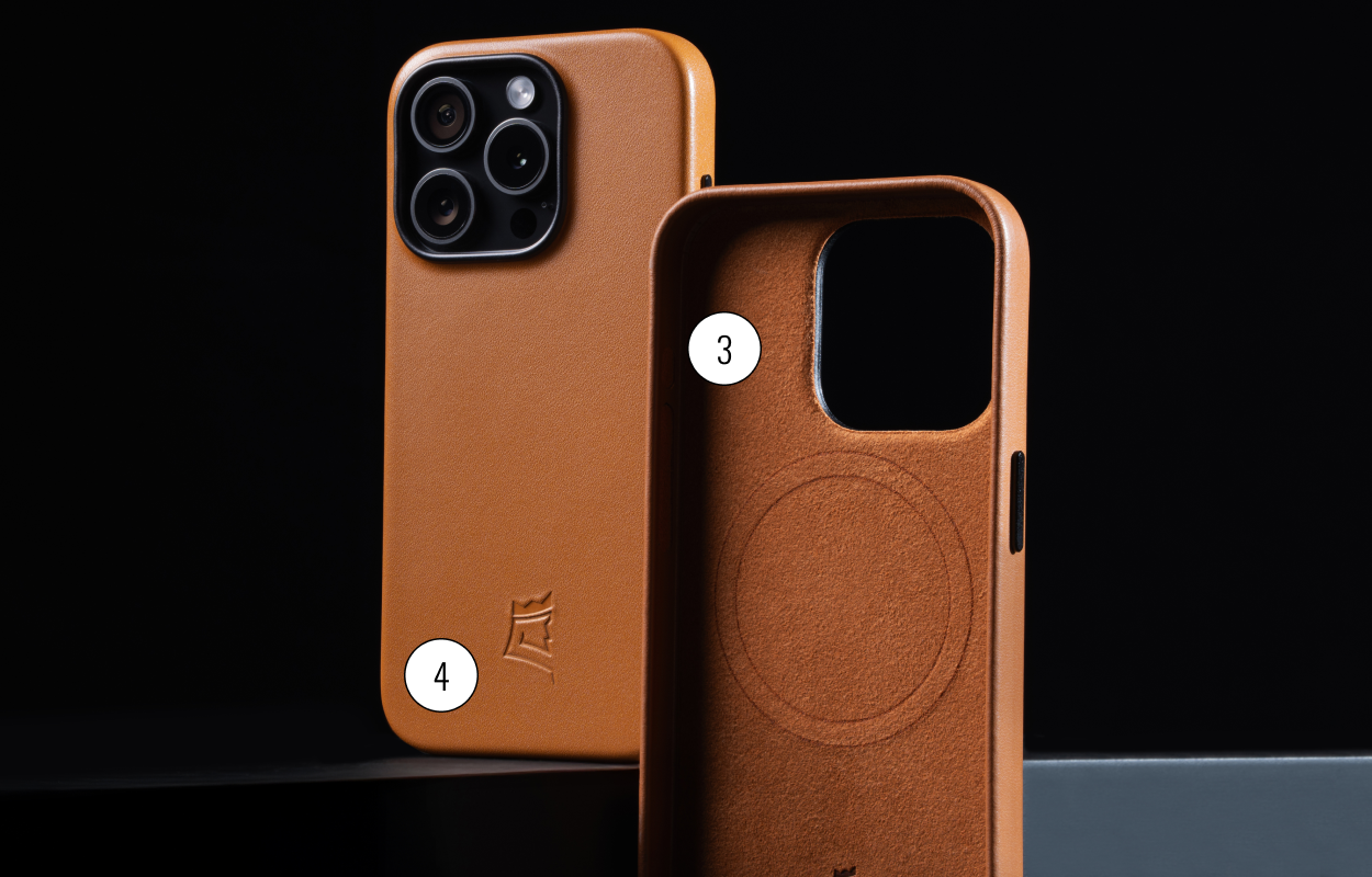 Two brown leather phone cases with camera cutouts on a dark background.