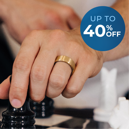 A person wearing a gold ring moves a black chess piece, with a blue 'Up to 40% Off' graphic.