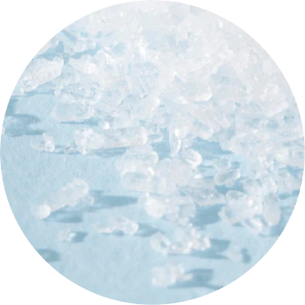 Close-up of scattered ice crystals on a blue surface.