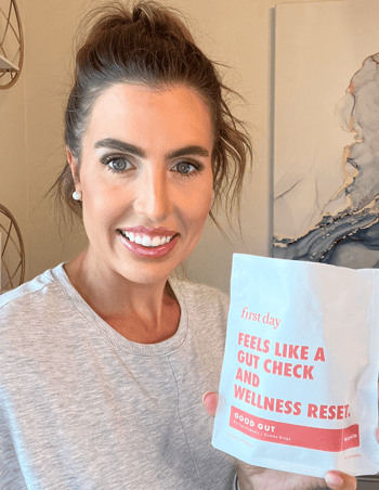 Person holding a wellness product package with text about gut health.