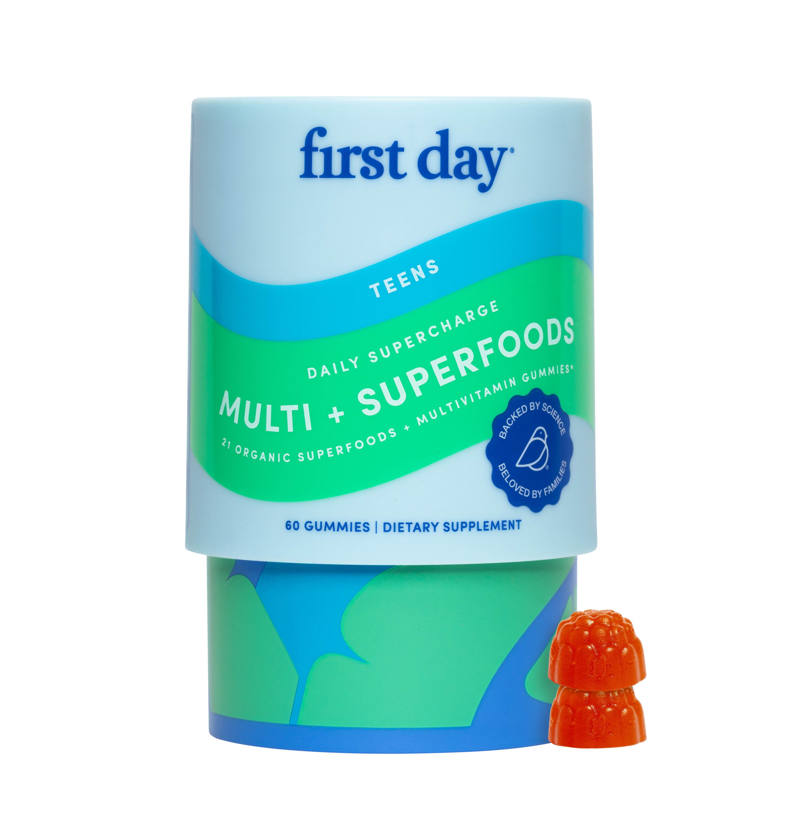 Container of teen multivitamin gummies with two orange gummies beside it.