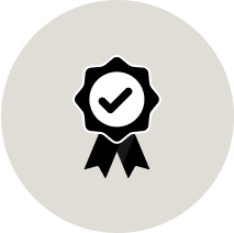 Icon of a checkmark on a ribbon emblem.