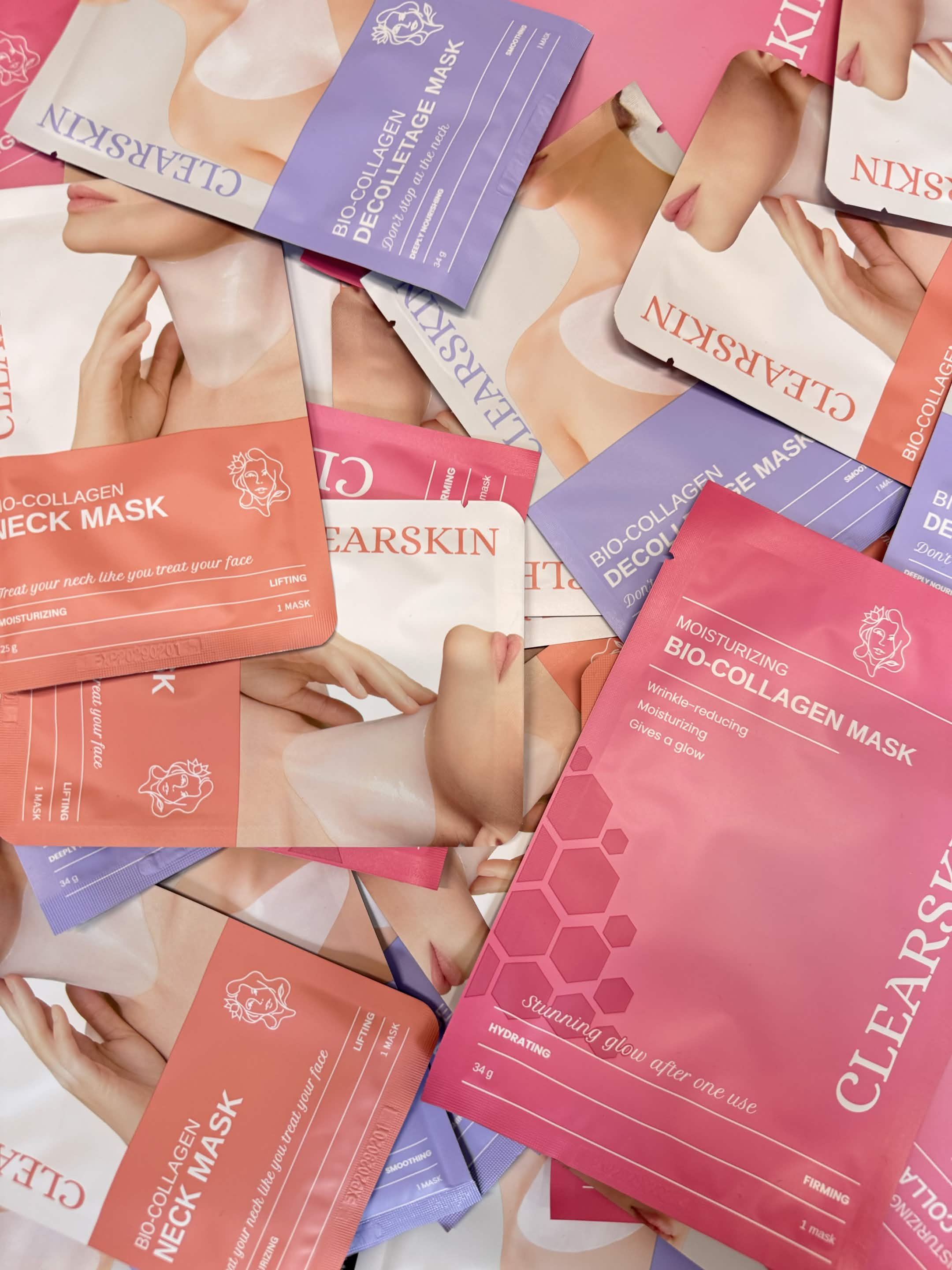 A scattered pile of colorful Clearskin brand bio-collagen mask packets for the neck and décolletage.
