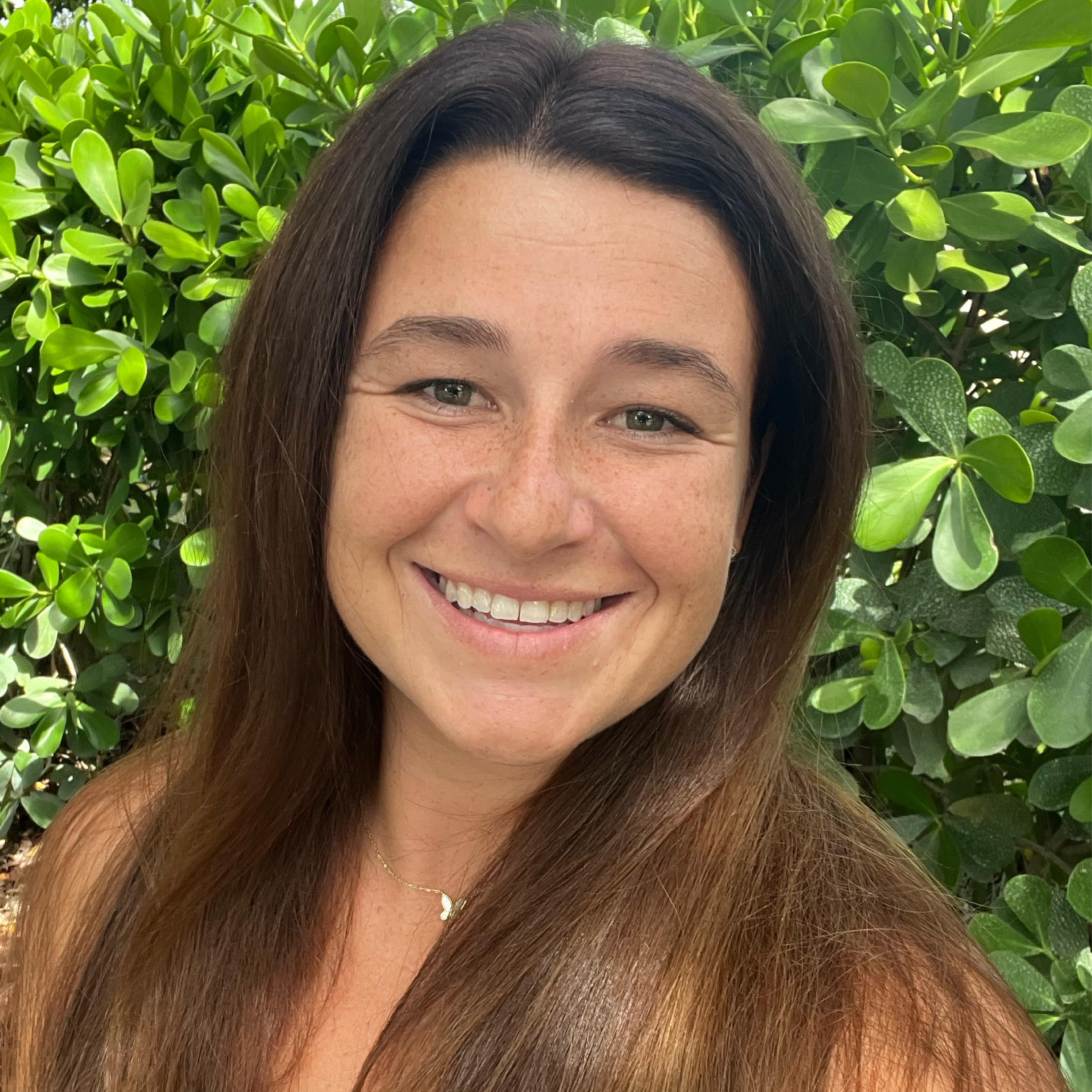 Woman smiling in front of an abstract painting.