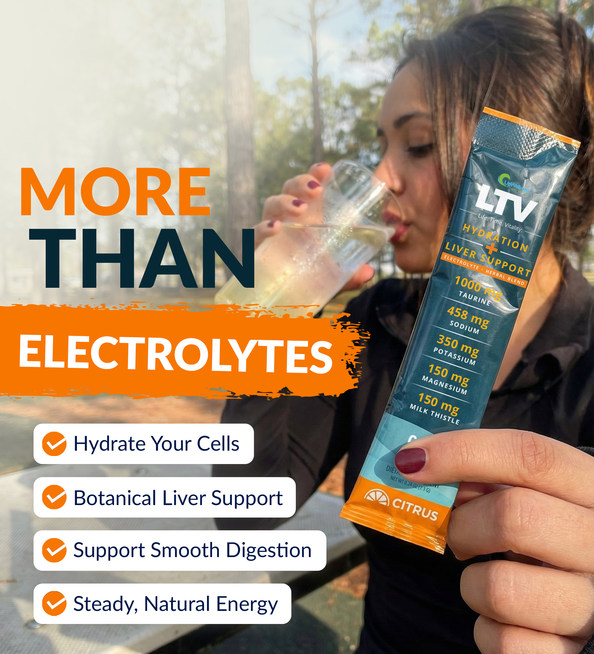 Woman drinks from a glass, holding an electrolyte supplement packet.