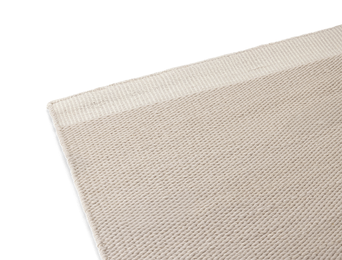 Beige textured fabric with a woven pattern.