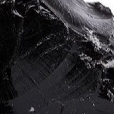 Close-up of a shiny, black, textured surface.