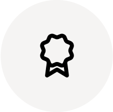 A black award ribbon icon on a white circular background.