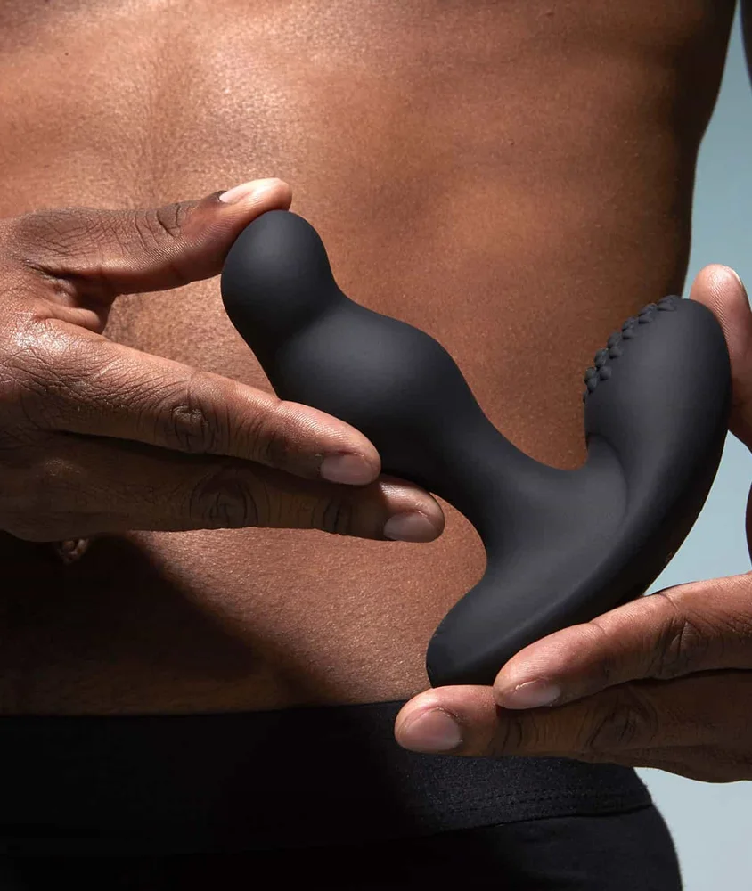 Person holding a Prostate Massager Giddy against their bare torso.