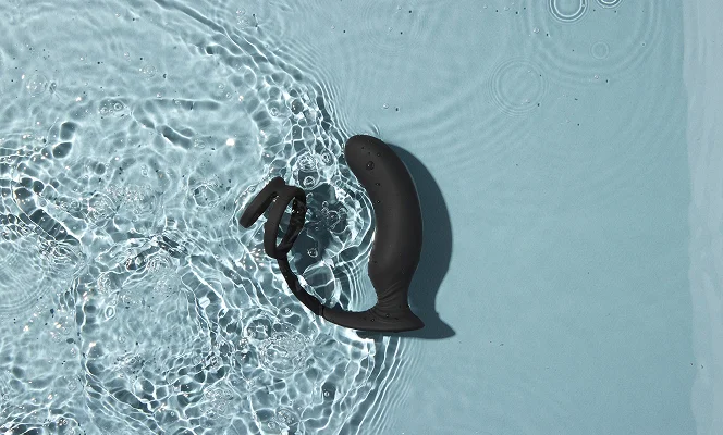 Prostate Massager Giddy Vulcan floating in clear water with ripples.