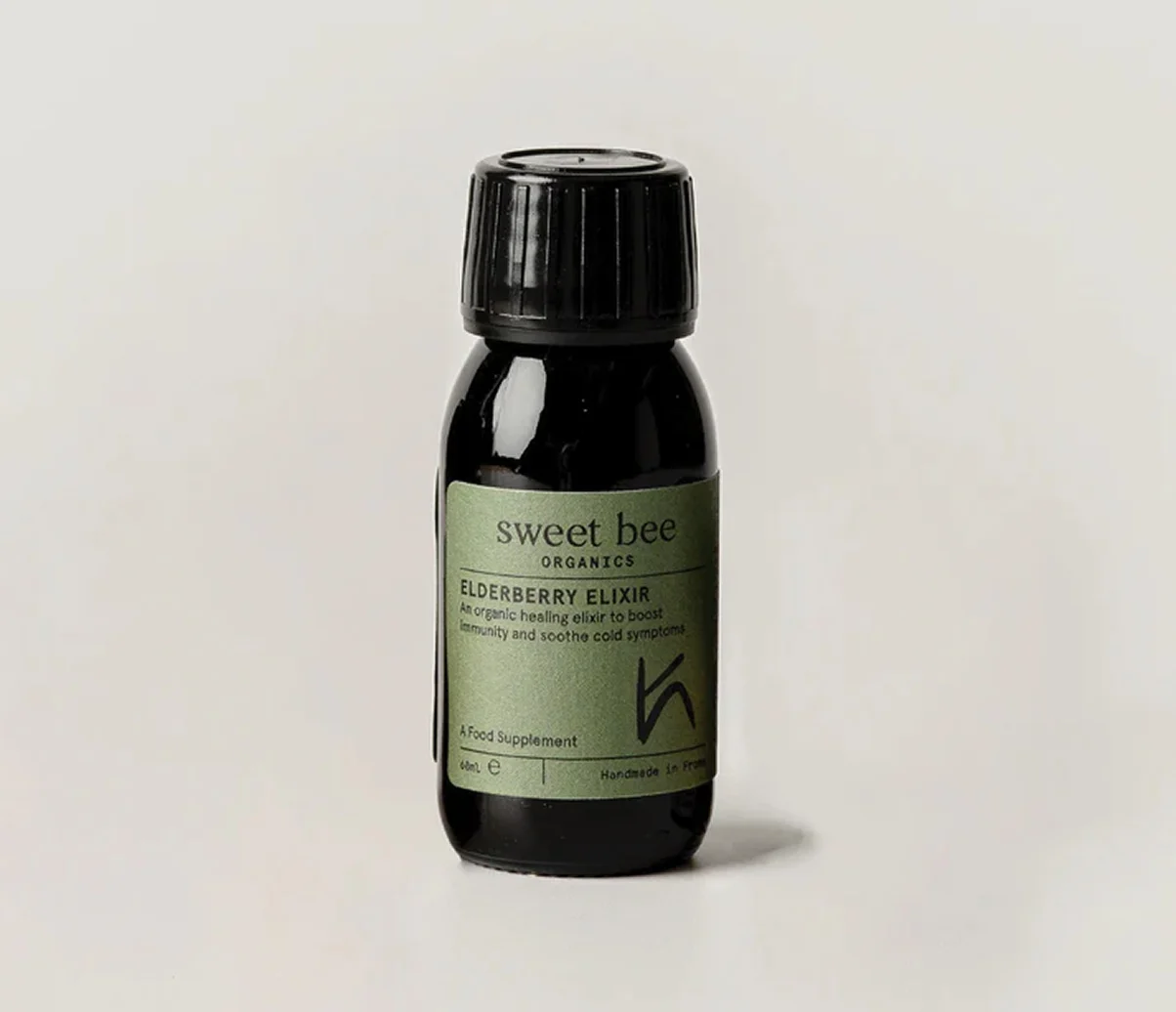 A bottle of Sweet Bee Organics Elderberry Elixir against a plain, off-white background.