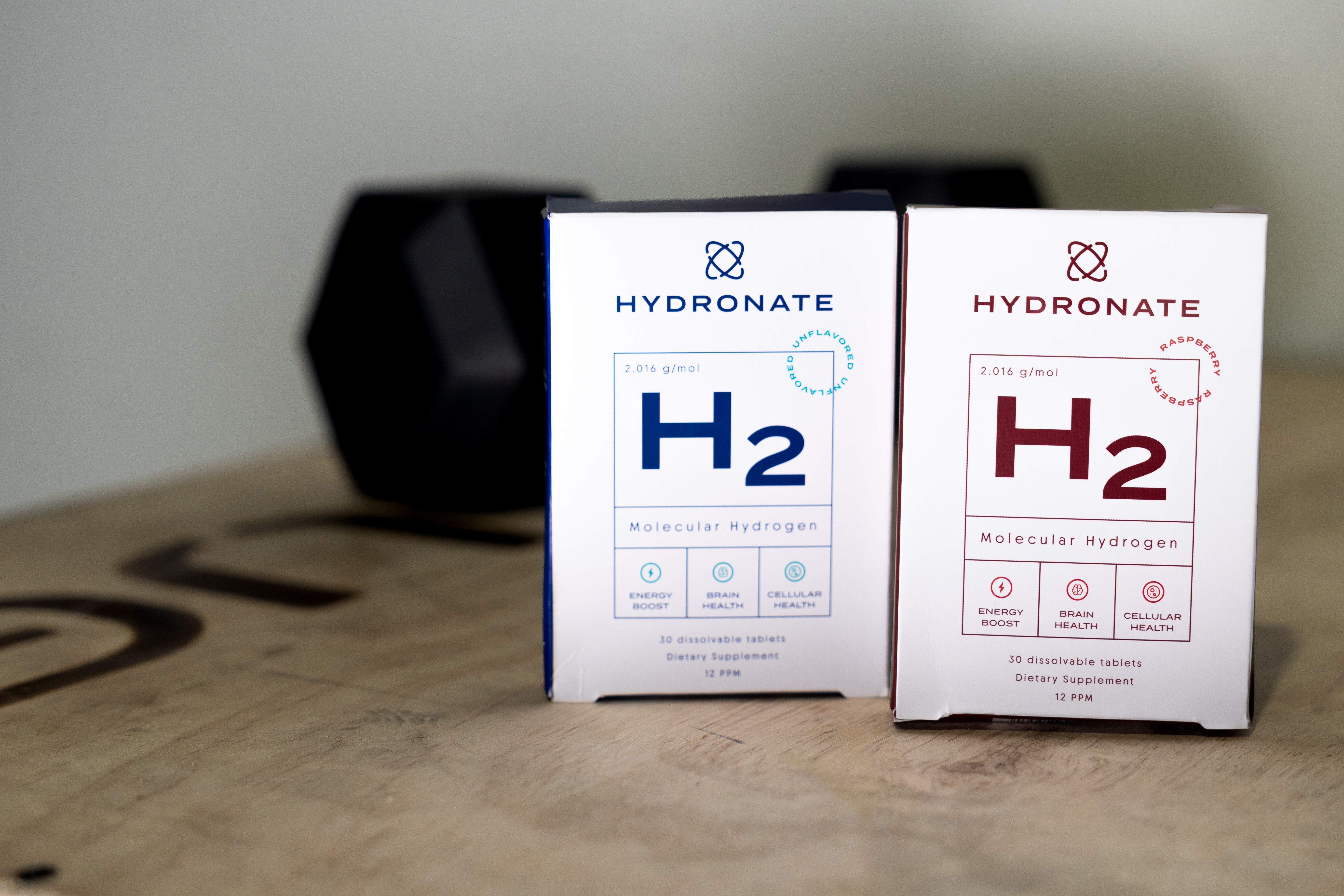 Two boxes of Hydronate H2 molecular hydrogen supplements on a wooden surface.
