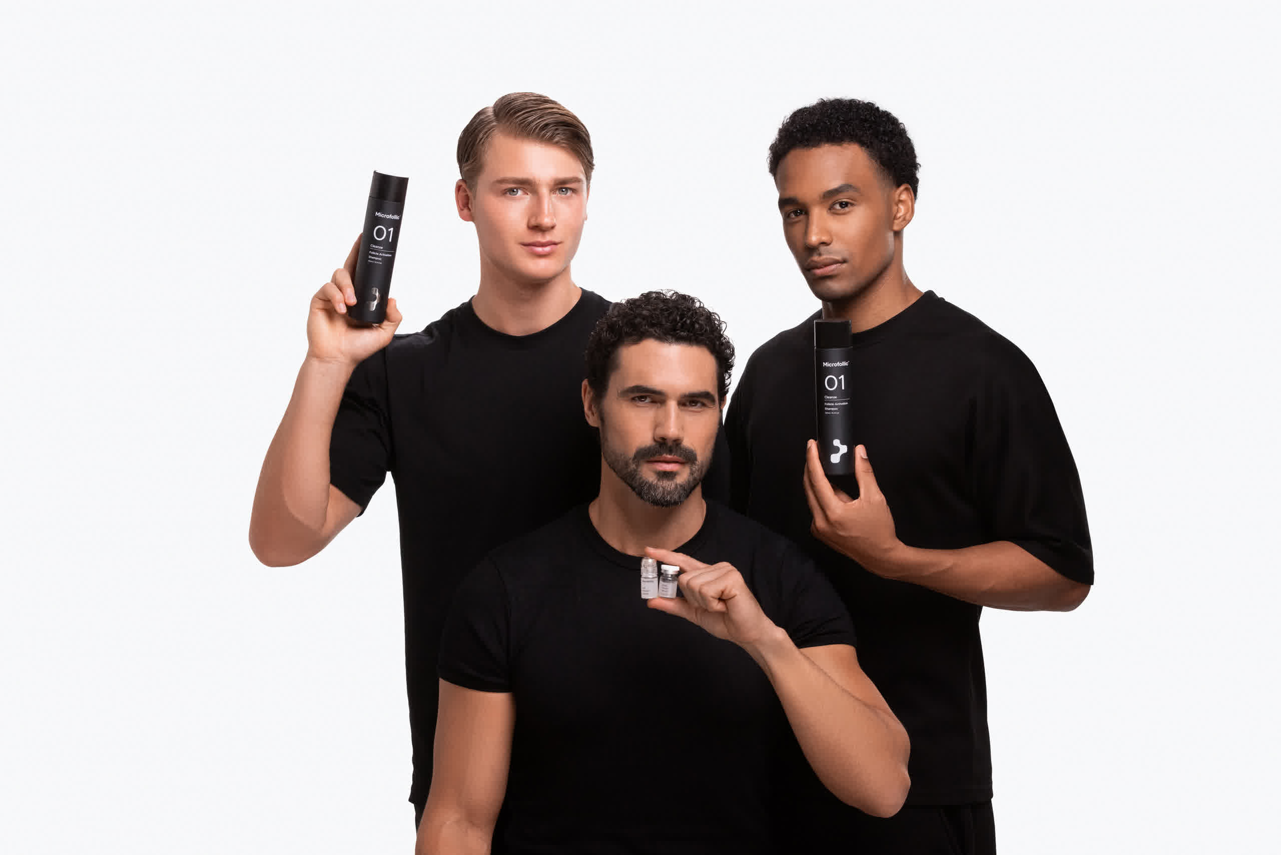 Three men in black t-shirts pose against a white background holding hair care products.