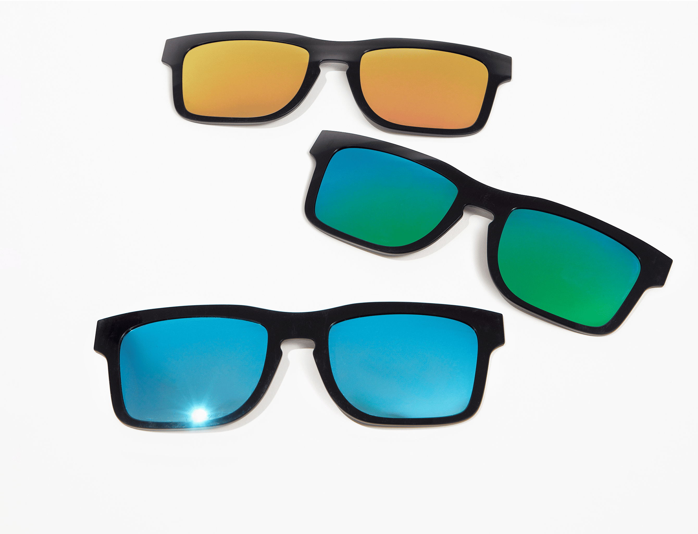 Three pairs of sunglasses with colored lenses on a white background.