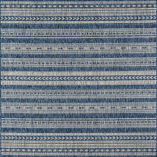 Blue and white geometric patterned textile with horizontal stripes.