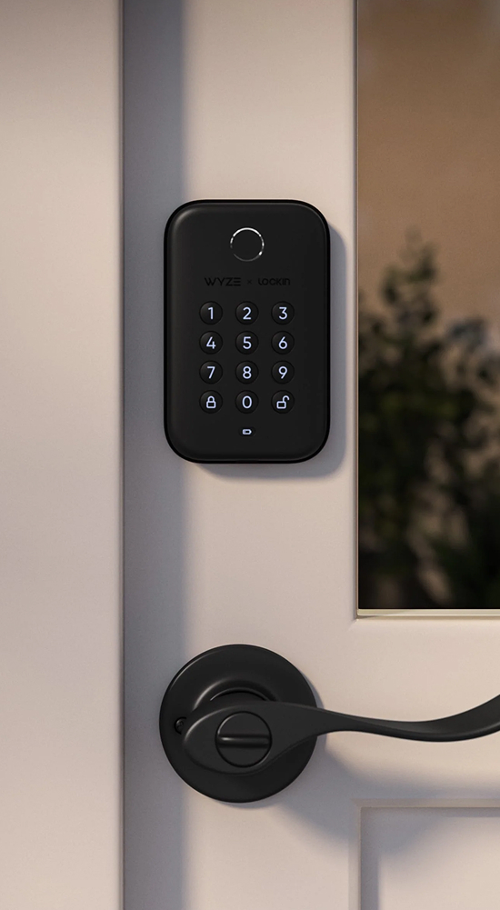 Black electronic keypad lock on a white door.