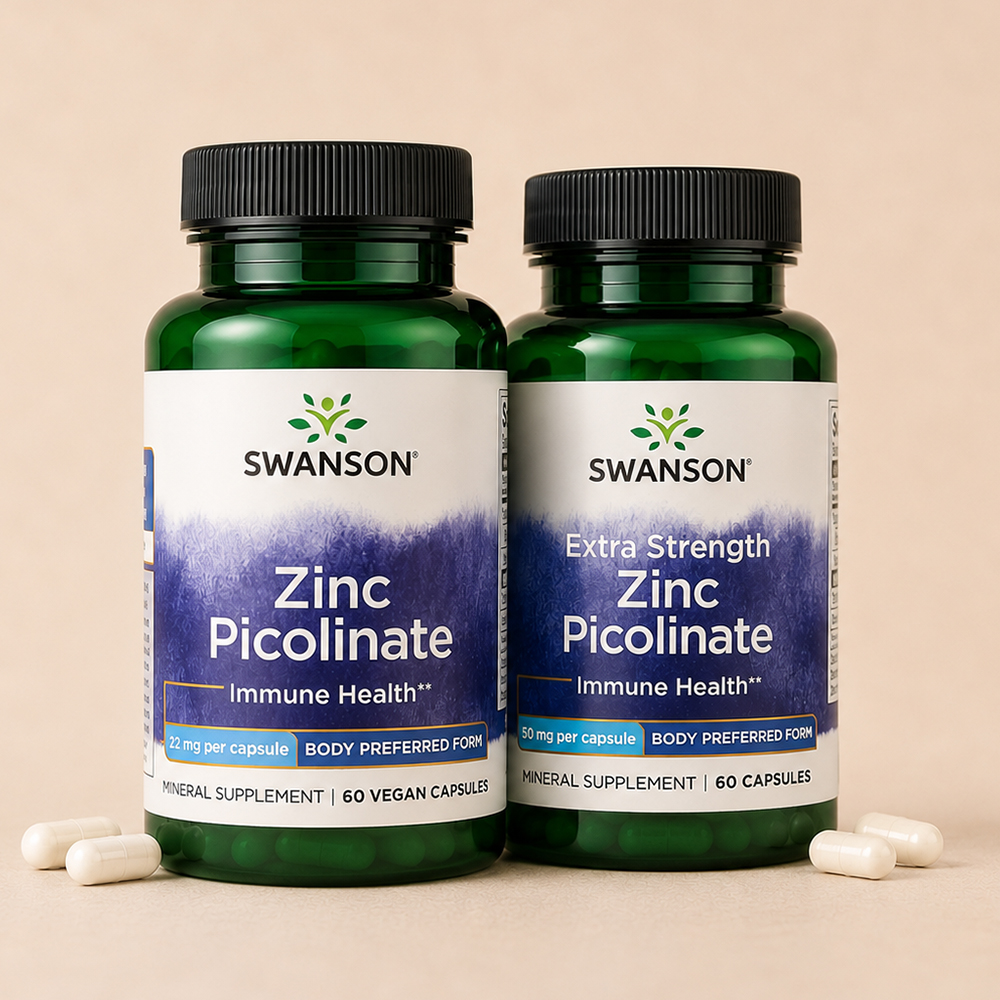 Two Swanson Zinc Picolinate supplement bottles, 22 mg and Extra Strength 50 mg, displayed on a beige background with capsules.
