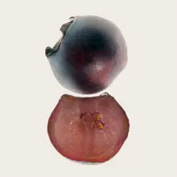 Whole grape above its halved counterpart on a plain background.