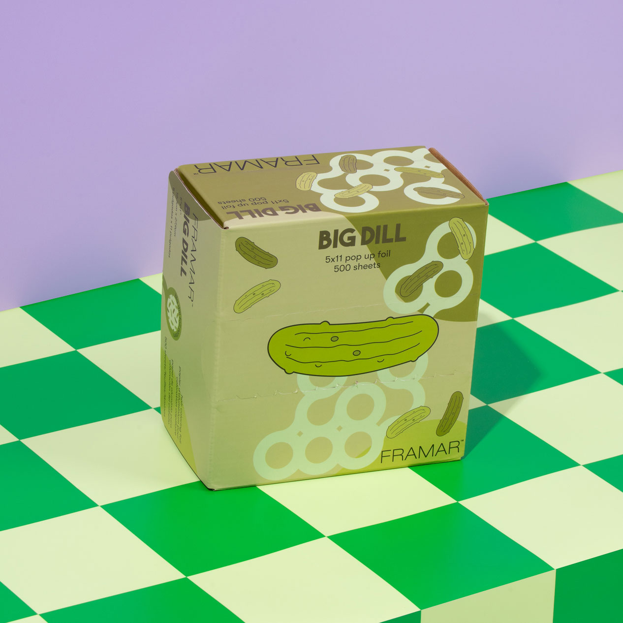 Box of 'Big Dill' foil sheets on a green checkered surface.