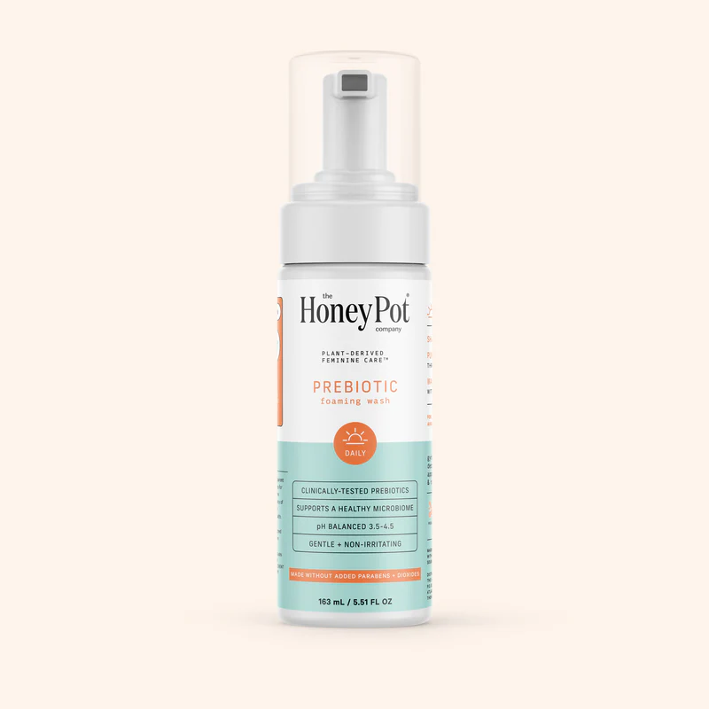 Bottle of Honey Pot prebiotic foaming wash on a plain background.