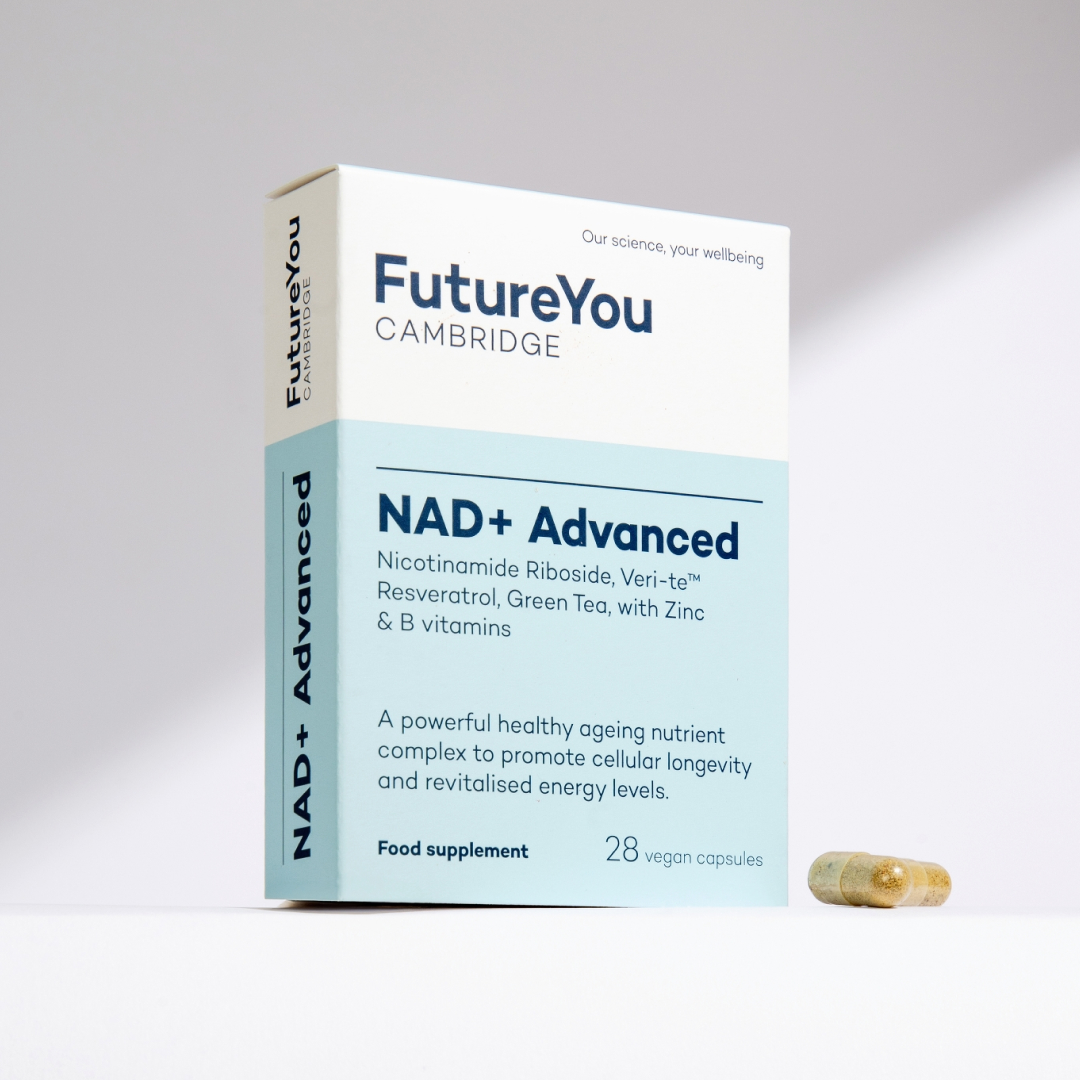 A box of FutureYou Cambridge NAD+ Advanced food supplement, with two capsules next to it on a white surface.