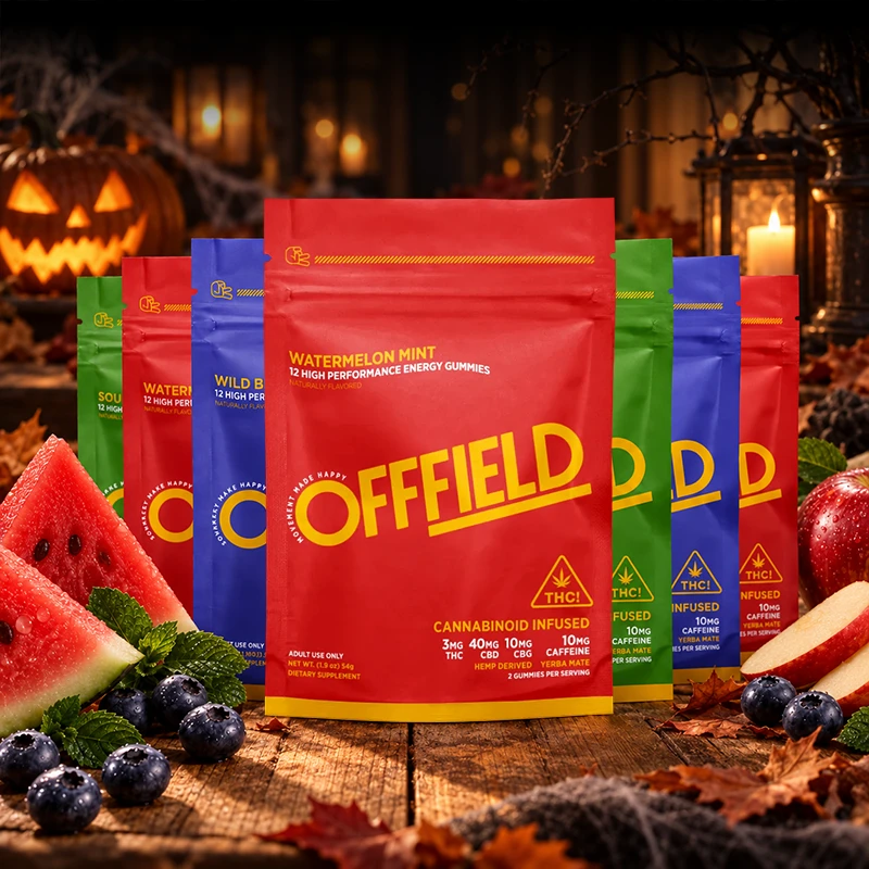 Colorful pouches of Offfield energy gummies are displayed with fresh watermelon, blueberries, and apples on a table.